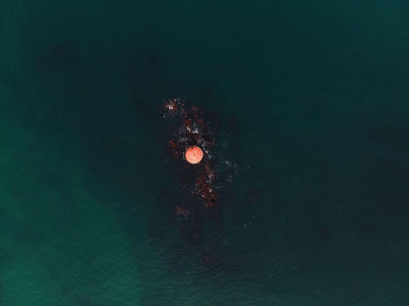 A moored monitoring buoy carrying water-quality instruments, working in open water